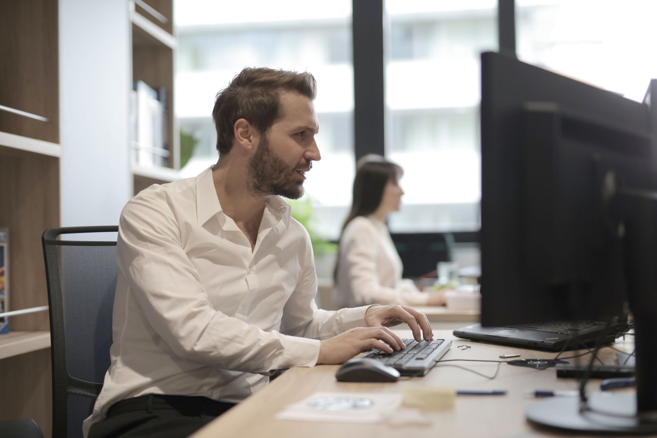 A member working in their own space, focused at their desk