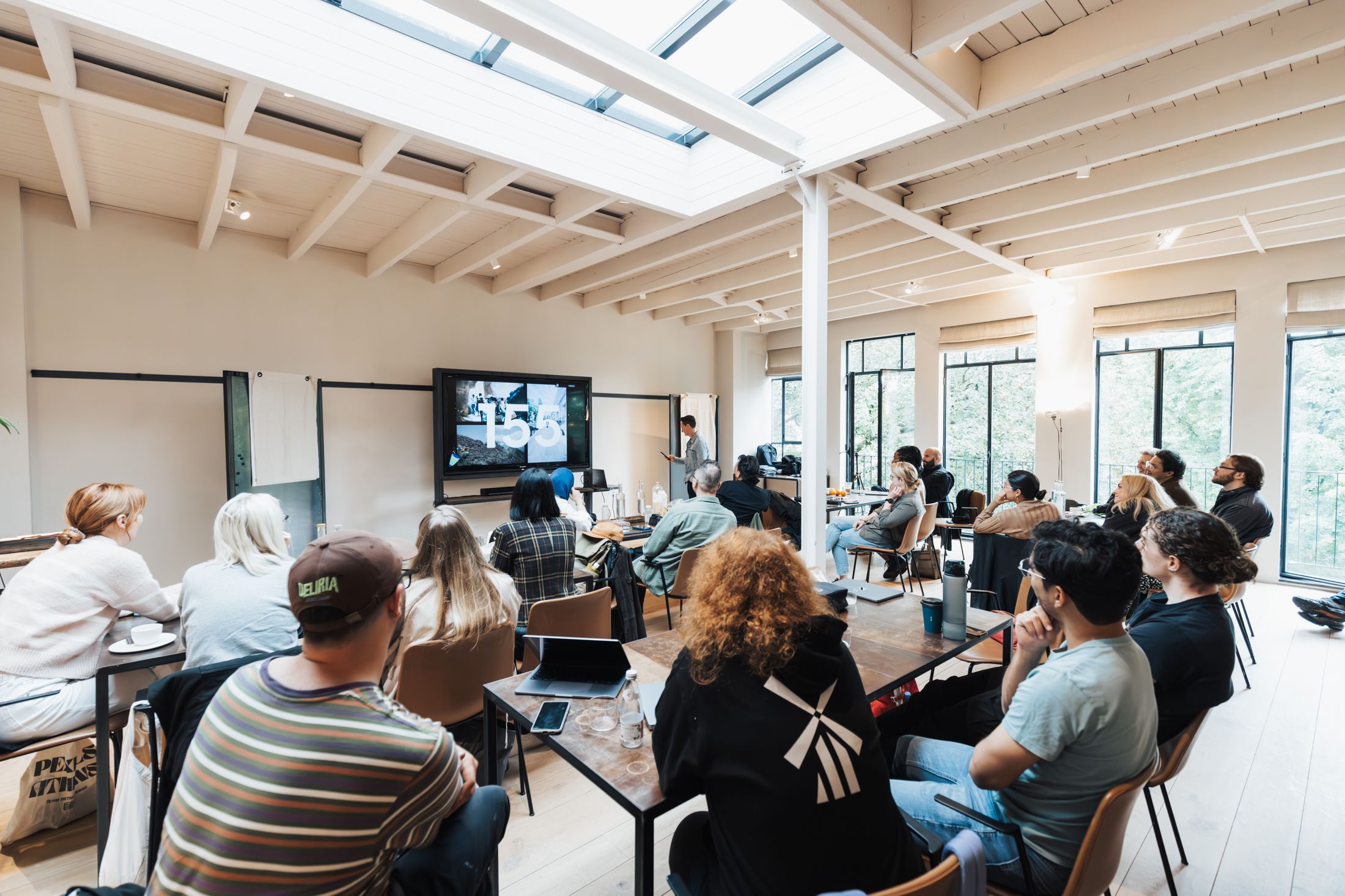 A network of people thinking together in a bright room — an afternoon of shared work